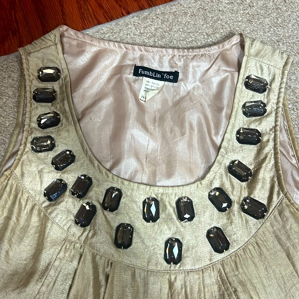 It’s a mini gold dress size S